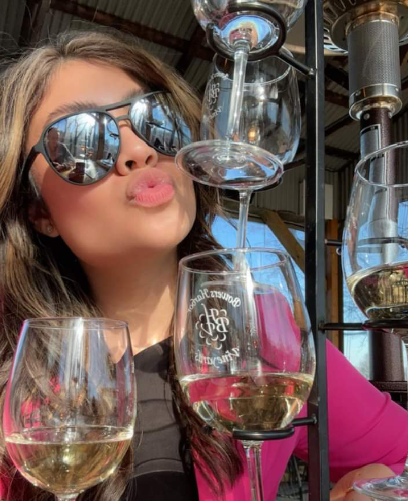 Woman enjoying wine tasting at winery.