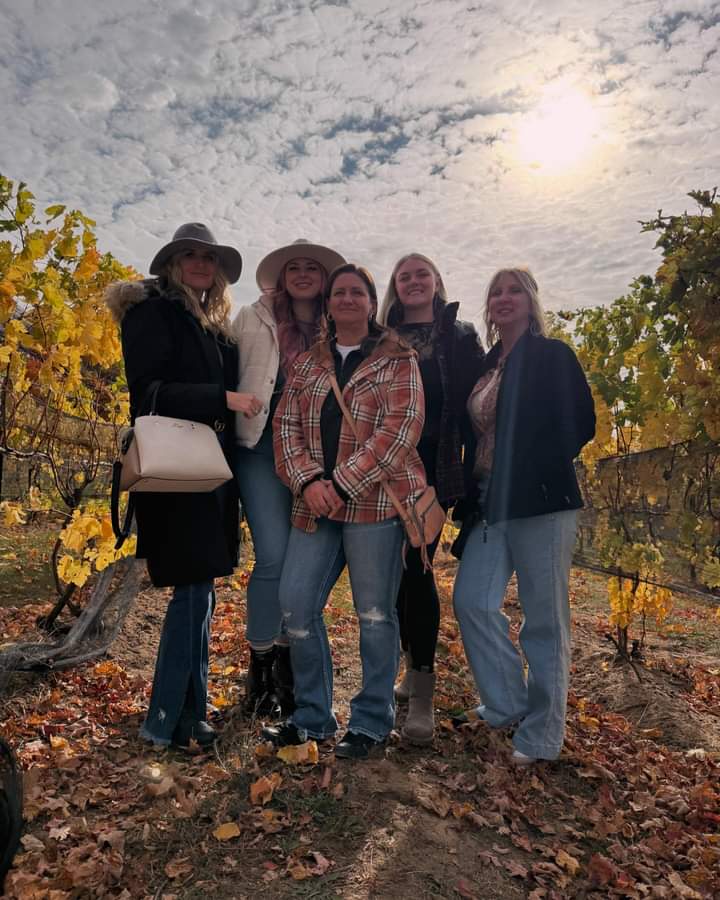 Five women friends at a vineyard.